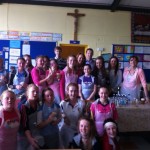 St. Aidan's NS principal with the girls and their mentors raising funds for their trip