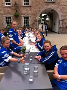 The girls having a bite to eat on the way to Derry before their 1st match